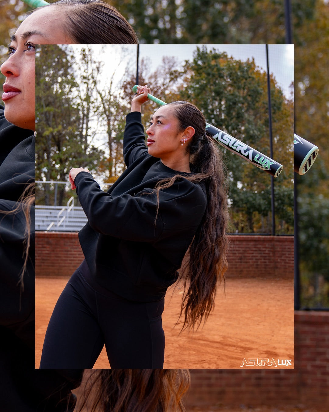 A woman with long hair in a black outfit holds a 2026 Marucci ASURA Lux (-11) Fastpitch Softball Bat (MFPASL11) on a dirt softball field, backed by trees and empty bleachers. Inset features a close-up of her face.