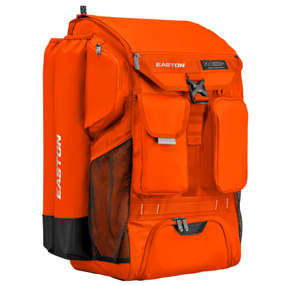 The Easton 5-Tool Phenom Backpack (5TPHENOMBP), in bright orange with EASTON branding, features multiple zippered compartments and mesh side pockets—a spacious baseball backpack shown on a plain white background.