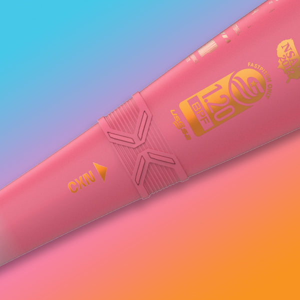 Close-up of a pink water polo ball with yellow text and graphics, including 1.20, BPF, and CYN on a vibrant gradient background of blue, orange, and pink.