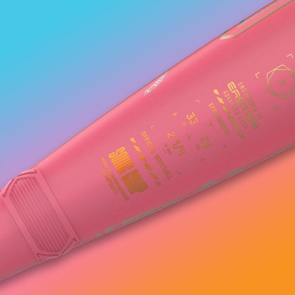 Close-up of a pink baseball bat with yellow and white text on it, set against a colorful gradient background of blue, purple, orange, and pink.
