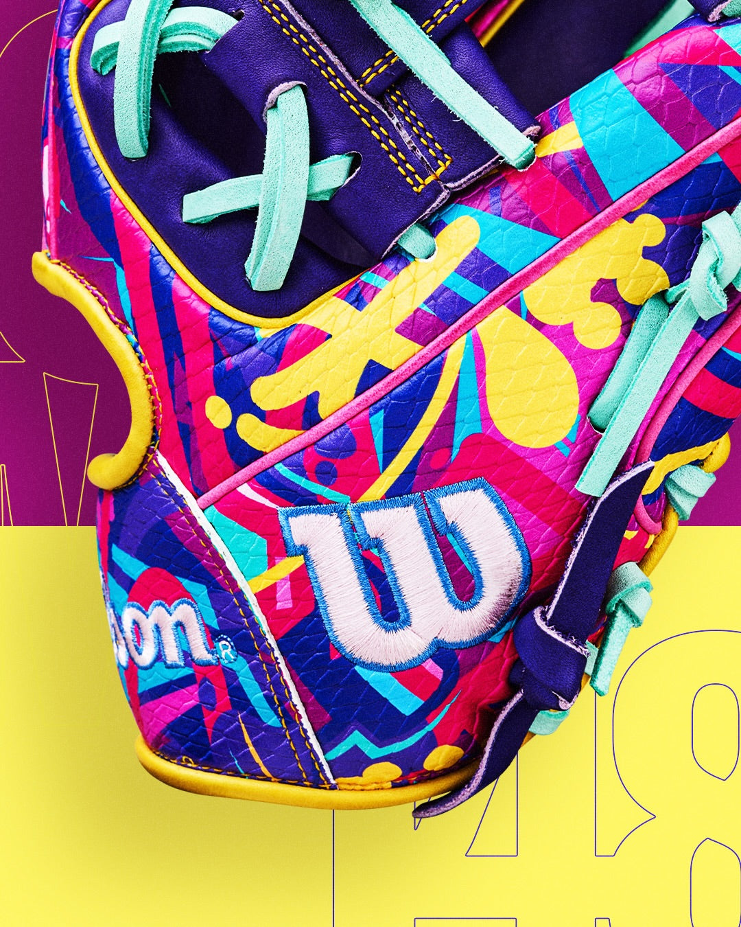 A close-up of the Wilson A2000 1786SS 11.5" Baseball Glove (GOTM January 2026, WBW104643115) showcases vibrant purple, blue, pink, yellow, and turquoise patterns with a white W logo and teal laces against a colorful background.