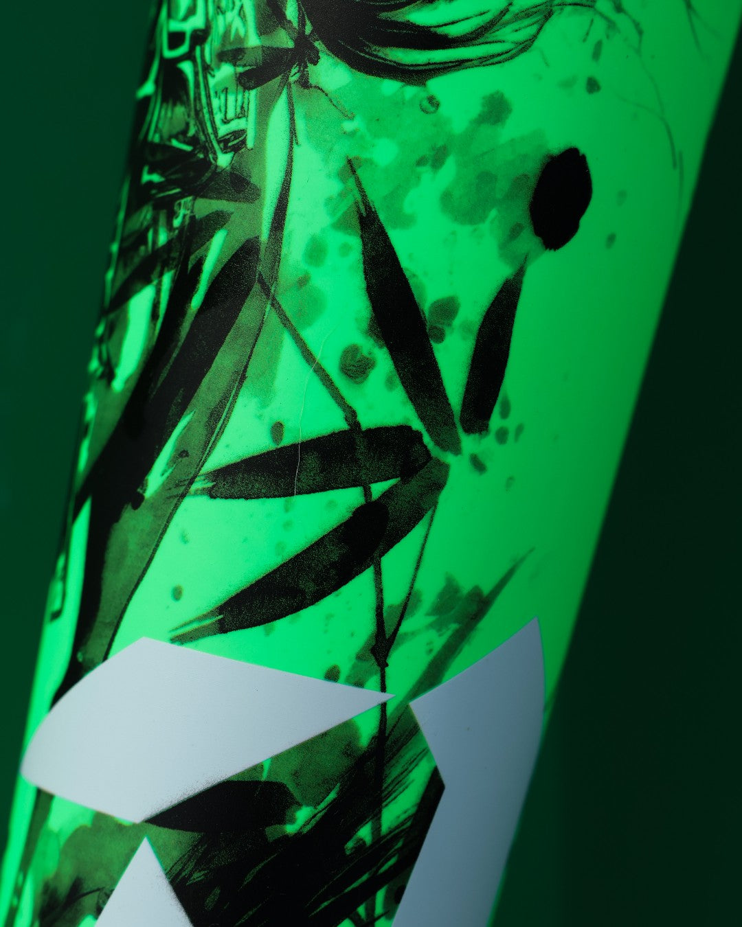 A close-up of a green surface featuring abstract black brush strokes and white geometric shapes, inspired by the X14 Alloy Barrel design on the 2026 DeMarini Exile Samurai (-3) BBCOR Baseball Bat: WBD2652010.