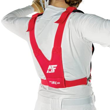 A person wearing a white long-sleeve shirt and a bright red back support harness with the white AF logo printed on the back. The person is adjusting something near their neck or shoulder.