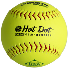 The Worth USA Hot Dot 12" 52/300 Composite Slowpitch Softball (AHD12CY) is bright yellow with red stitching, features the Worth logo, "Hot Dot C-LOK Compression," and USA/ASA certification printed on its surface.