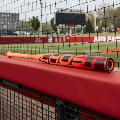 The 2026 Easton Ghost Advanced (-10) Fastpitch Softball Bat by Easton rests on a fence, its sleek design promising unmatched power and precision.