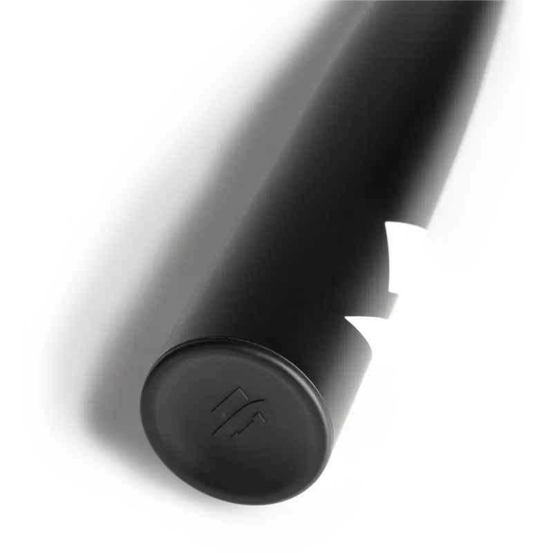 A close-up of the black handle of a baseball bat on a white background, featuring a subtle logo embossed on the end cap.