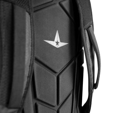 Close-up of the All Star MVP PRO Series Catcher's Backpack (BBCBP) in black, featuring a geometric padded back panel and white star logo. A shoulder strap and handle for your glove vault are also visible on the sides.