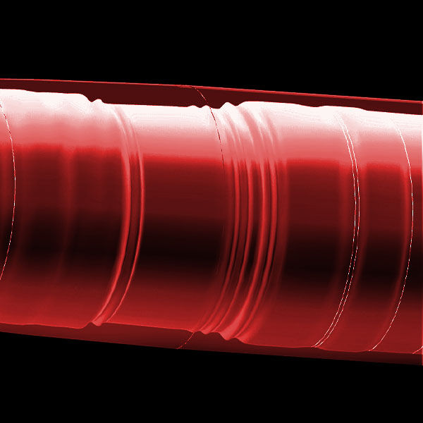Close-up view of a red corrugated plastic tube or pipe with ridged, repeating grooves, set against a black background.