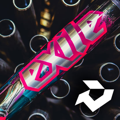 A close-up of a metallic DeMarini Exile Cyborg (-3) BBCOR Baseball Bat (2026, WBD2654010) labeled "exile" in bold, pink-outlined letters, with circular metal pipes and a white geometric logo in the lower right corner.