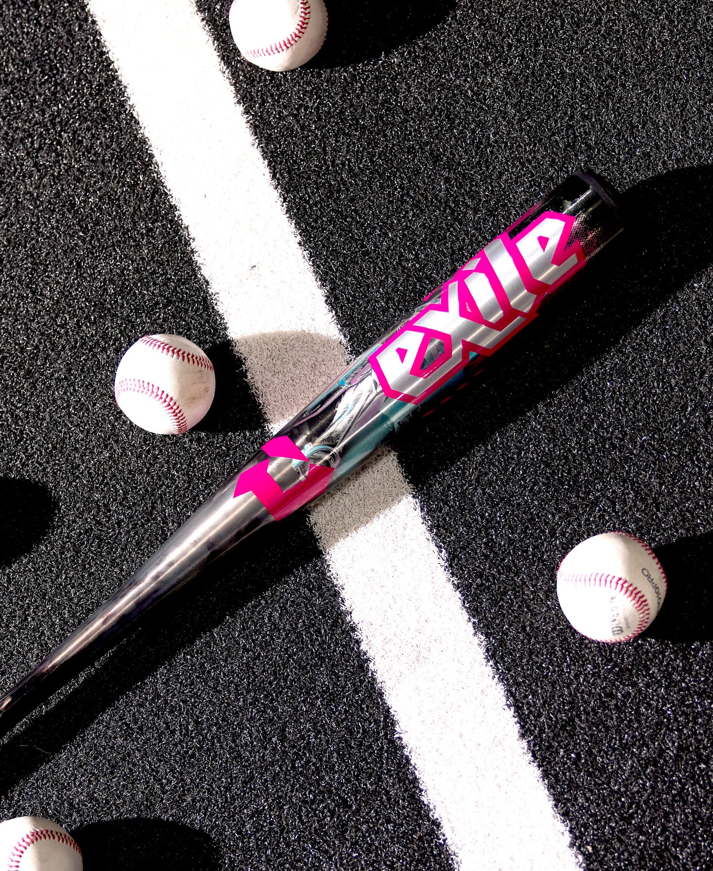 The 2026 DeMarini Exile Cyborg (-3) BBCOR Baseball Bat (WBD2654010), featuring bold pink and white lettering, rests on a black surface with five baseballs, showcasing its powerful X14 Alloy Barrel.