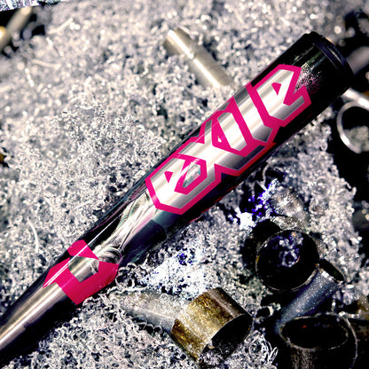 A 2026 DeMarini Exile Cyborg (-3) BBCOR Baseball Bat (WBD2654010) lies on metal shavings and scraps, its durable X14 Alloy Barrel highlighted.