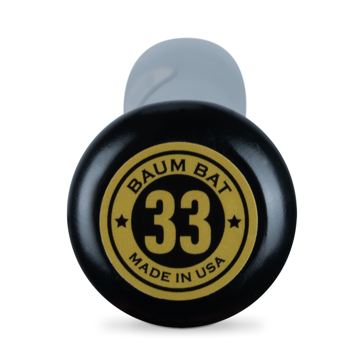 Close-up of the knob of a black Baum Gold Stock AAA Pro Balanced Composite Wood Bat: BBM, featuring a yellow and black circular label reading BAUM BAT 33 MADE IN USA with two stars. The partially visible handle is wrapped in a gray grip—engineered with advanced composite wood bat technology for elite performance and proudly handcrafted in the USA by Baum.