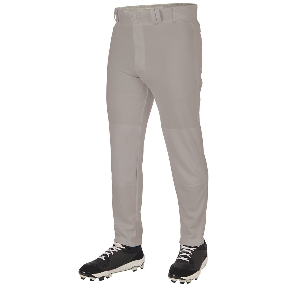 A person stands against a white background wearing Champro Sports Youth Triple Crown 2.0 Tapered Baseball Pants (BP64Y) in light gray, paired with black cleats featuring white laces. Only the pants and shoes are visible; the upper body is out of frame.
