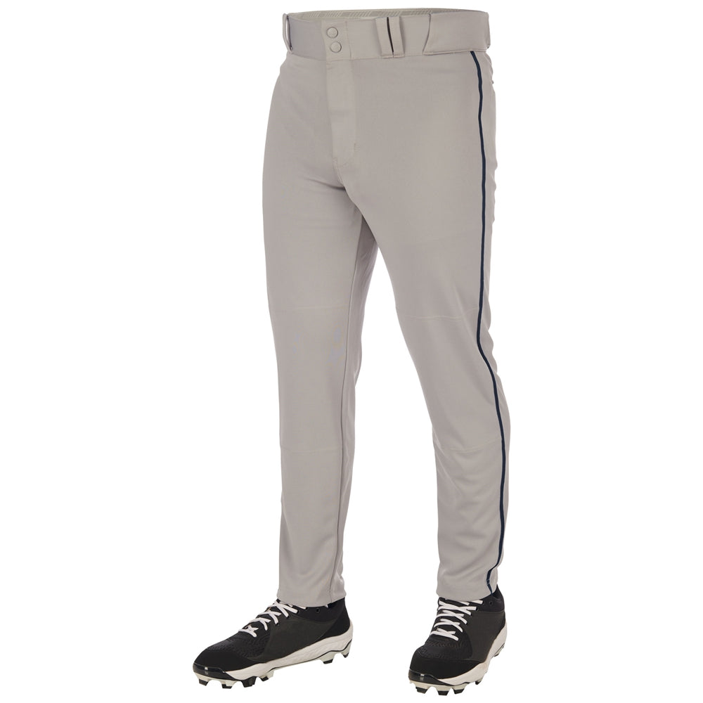 A person wears Champro Sports Triple Crown 2.0 BP66 light gray tapered baseball pants with a dark side stripe and belt, plus black cleats with white laces. Made from durable pro-weight fabric. Upper body not visible.