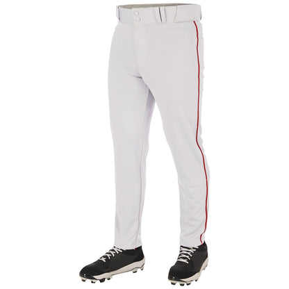 The image shows a person wearing Champro Sports Triple Crown 2.0 Tapered Baseball Pants with red piping (BP66), made from pro-weight fabric, paired with black cleats with white laces; the photo is cropped from the waist down.