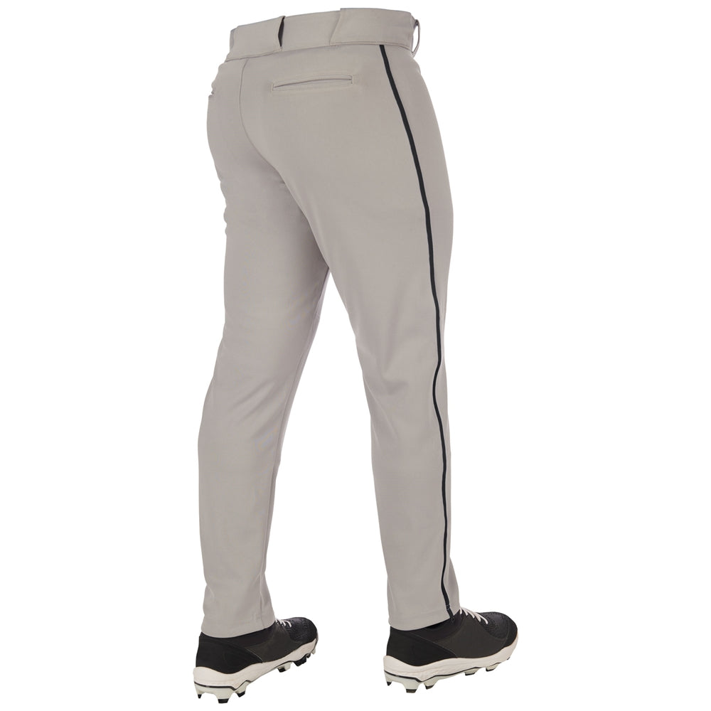 A person wearing Champro Sports Triple Crown 2.0 BP66 light gray tapered baseball pants with black piping and black cleats, viewed from the back.