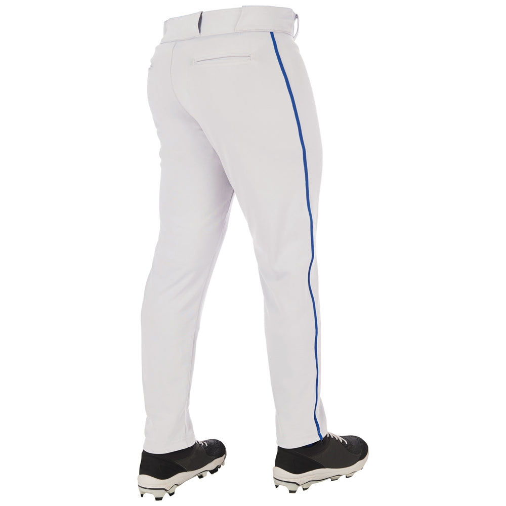 A person wearing Champro Sports Adult Triple Crown 2.0 Tapered Baseball Pants with piping (BP66) featuring a blue side stripe, pro-weight fabric, belt, and back pocket detail, viewed from the back with black cleats.