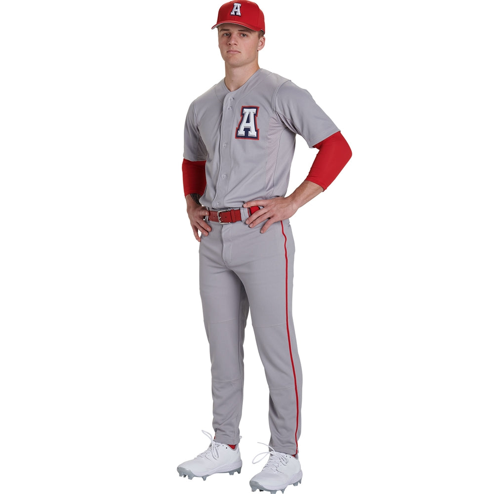 A baseball player wearing Champro Adult Triple Crown 2.0 Tapered Baseball Pants with Piping (BP66) by Champro Sports, a grey uniform with red accents, red long-sleeve undershirt, red cap, and white cleats stands hands on hips. Jersey has large A logo.