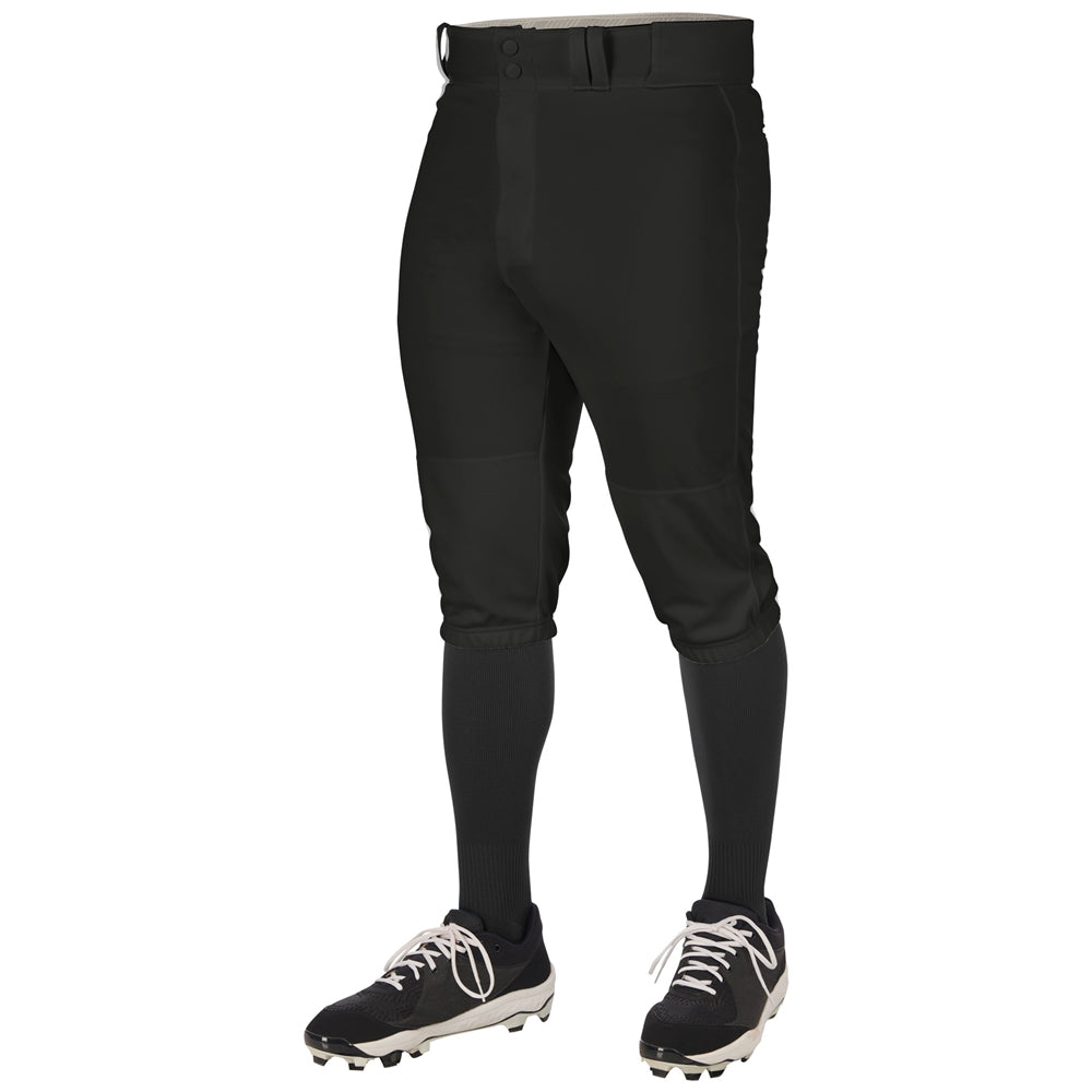 A person models Champro Sports Triple Crown 2.0 Knicker Baseball Pants (BP68) in black, paired with black knee-high socks and black-and-white cleats against a white background; only the lower body is visible.