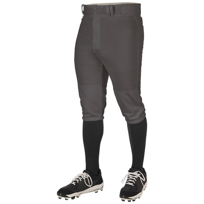 A person wearing Champro Youth Triple Crown 2.0 Knicker Baseball Pants (BP68Y) by Champro Sports, paired with black knee-high socks and black cleats with white laces, shown from the waist down against a white background.