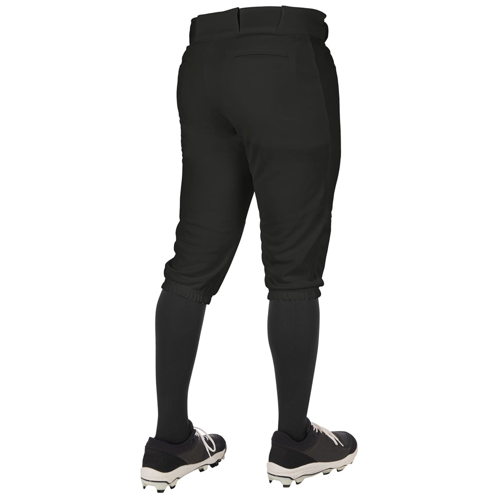 A person is seen from behind wearing Champro Sports Triple Crown 2.0 knicker baseball pants (BP68), black knee-high socks, and black cleats with white soles. The pants have belt loops and back pockets for a classic look.