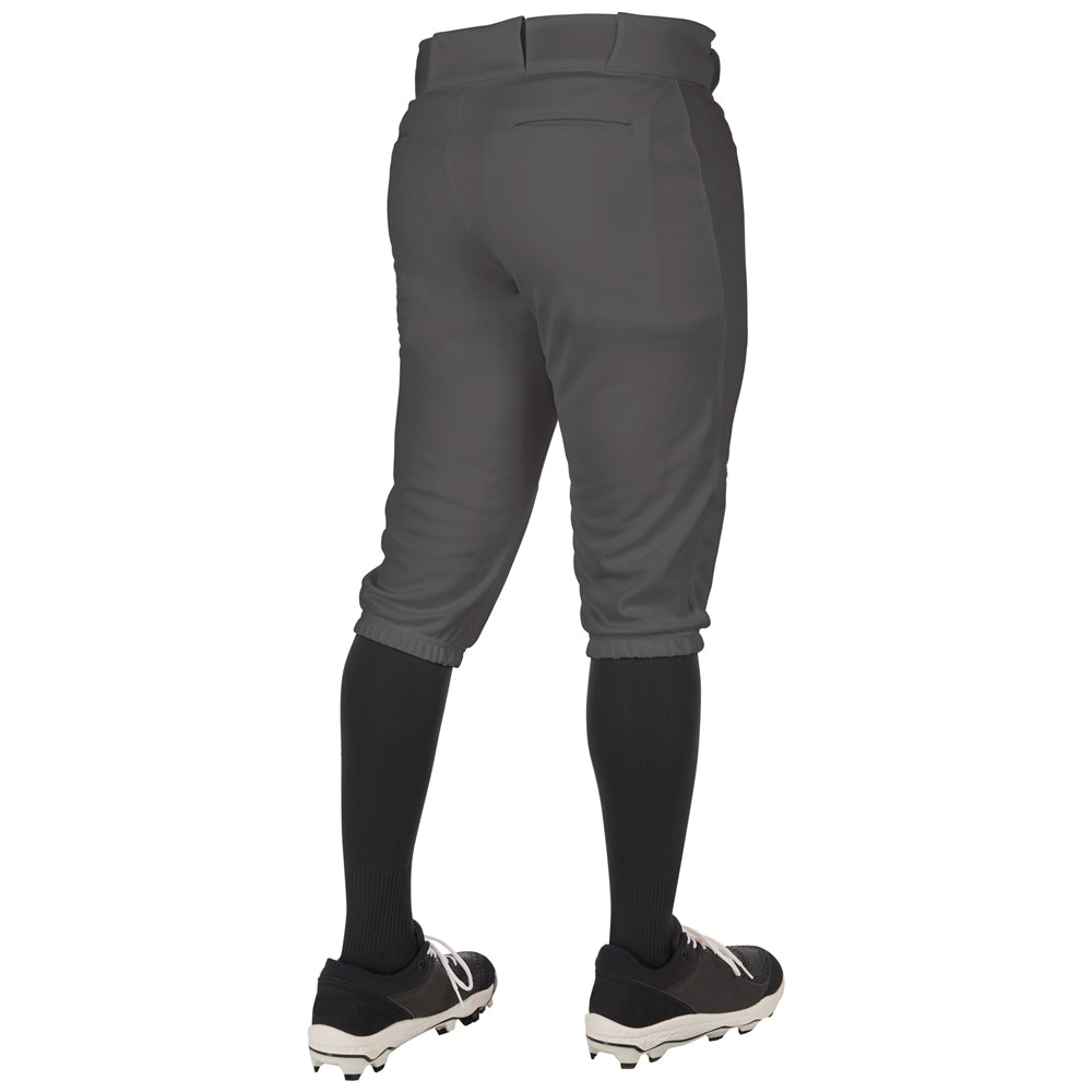 A person wearing Champro Sports Youth Triple Crown 2.0 Knicker Baseball Pants (BP68Y), black knee-high socks, and black cleats stands with their back to the camera.