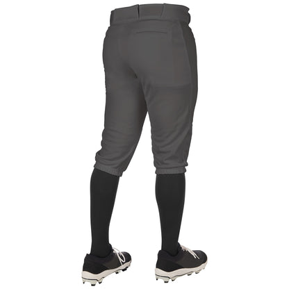A person wearing Champro Sports Youth Triple Crown 2.0 Knicker Baseball Pants (BP68Y), black knee-high socks, and black cleats stands with their back to the camera.