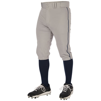 Wearing Champro Sports Youth Triple Crown 2.0 Knicker Baseball Pants with Piping (BP70Y), navy blue socks, black cleats, and a matching belt, the person stands on a white background with only the lower body visible.