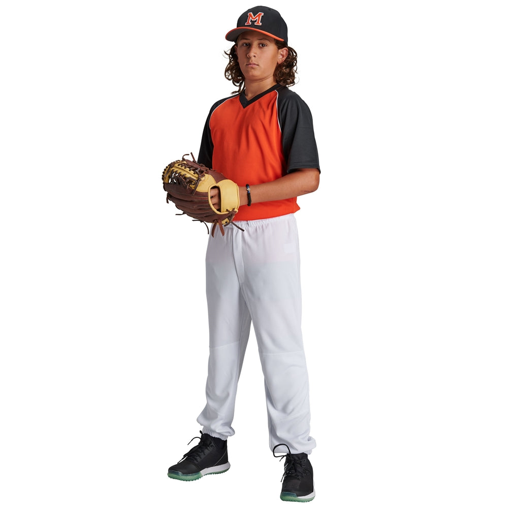 A young baseball player wearing a Champro Sports black and orange jersey, Champro Youth Cycle Pull Up Baseball Pants with Belt Loops (BPPU2), and a black “M” cap stands ready with his glove.
