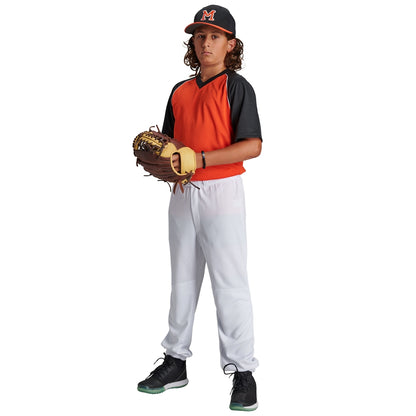 A young baseball player wearing a Champro Sports black and orange jersey, Champro Youth Cycle Pull Up Baseball Pants with Belt Loops (BPPU2), and a black “M” cap stands ready with his glove.