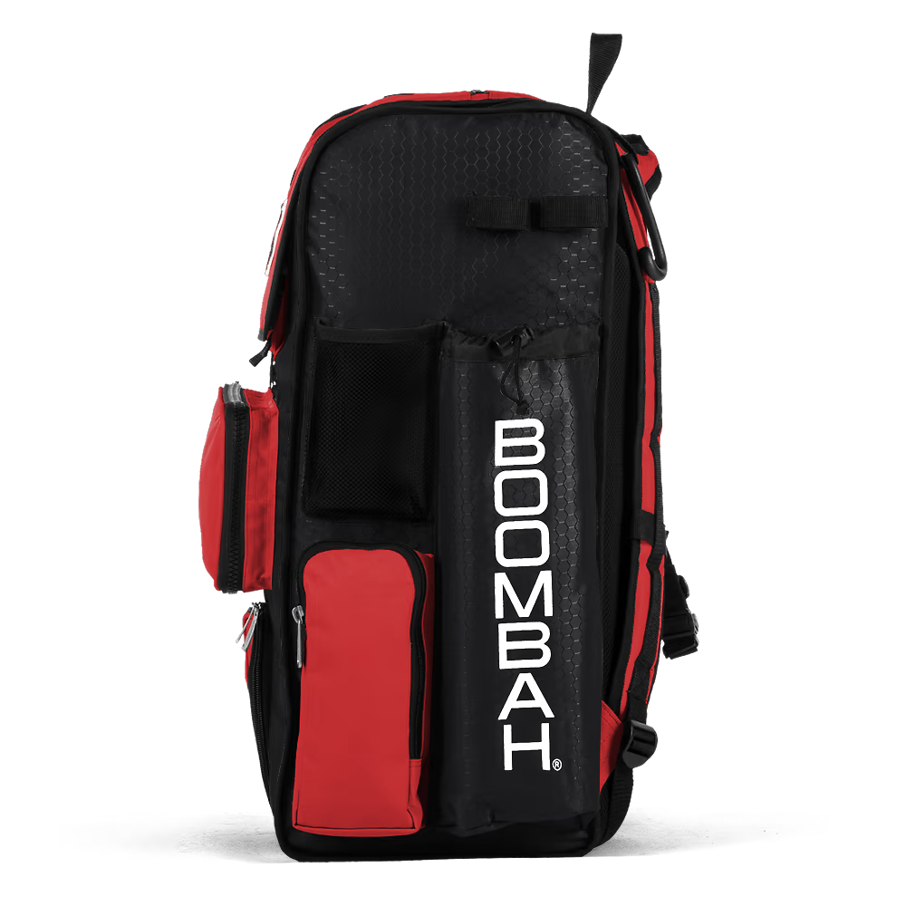 The Boombah Superpack Bat Bag: BPSP by Boombah is a spacious black and red backpack with multiple zippered compartments, mesh pockets, and "BOOMBAH" printed vertically in white on the side.