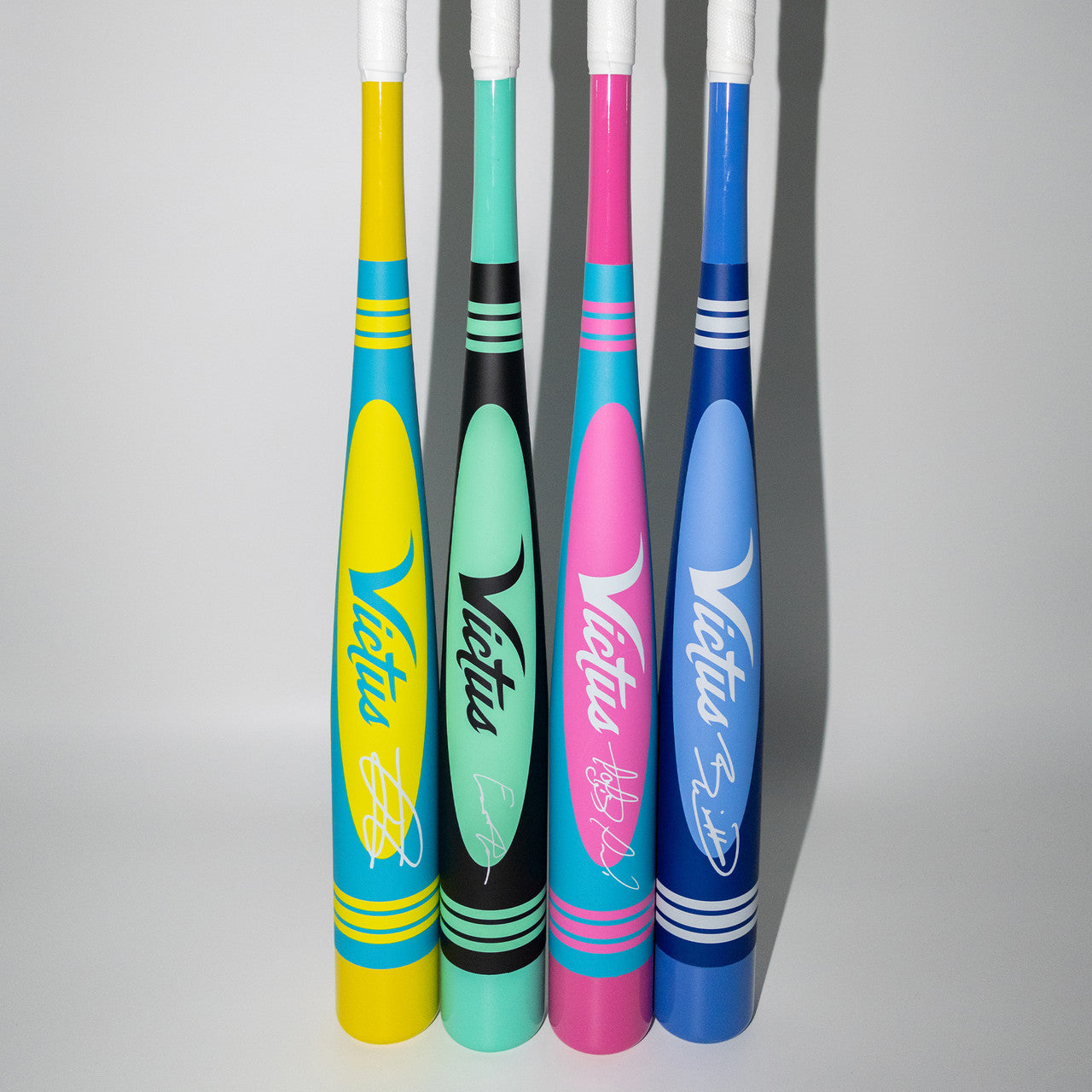 A group of colorful baseball bats, including the durable and high-performing 2025 Victus Vibe Pro-Crayon Julio Rodriguez (-8) USSSA bat from Victus.