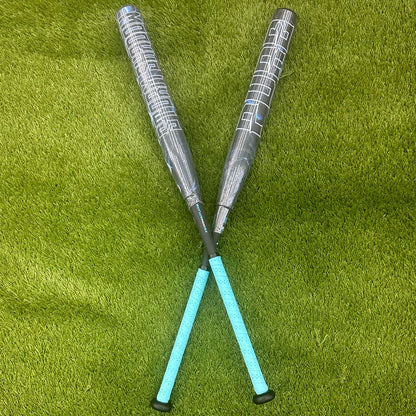 A pair of composite bats, including the Pure Sports 2025 Storm Shadow 13″ Balanced USA Slowpitch Softball Bat (5147M91B), rests on the grass.