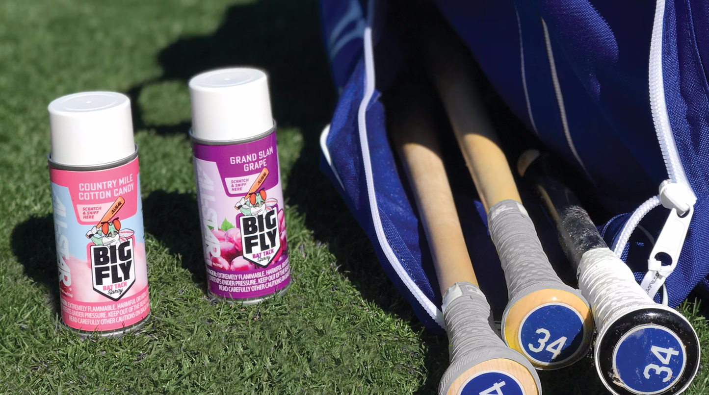An All Star baseball bat with a secure grip and All Star Big Fly Bat Tack Spray (BFSP1) can rest on the grass.