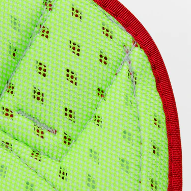 Close-up of a green padded fabric with small diamond-shaped perforations and red stitching along the curved edge.