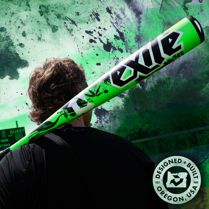 A person with brown hair holds a bright green 2026 DeMarini Exile Samurai (-3) BBCOR Baseball Bat: WBD2652010 over their shoulder. The green abstract background features a "Designed + Built in Oregon, USA" circular stamp in the lower right corner.