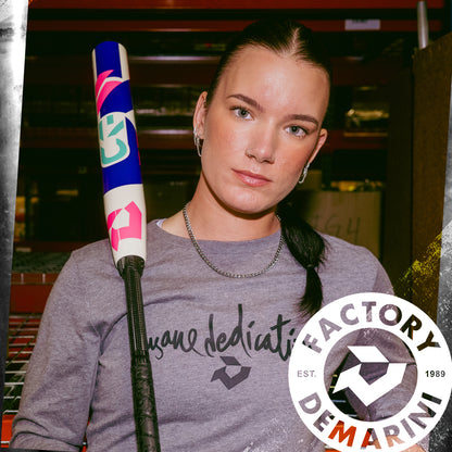 A woman holding a DeMarini 2026 CF (-11) Fastpitch Softball Bat (WBD2630010).