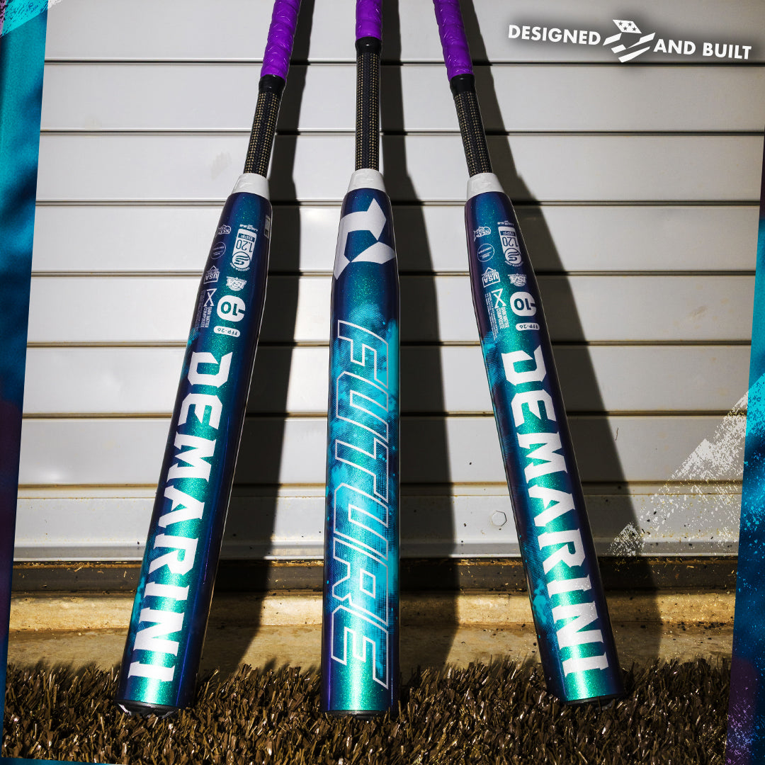 Three vibrant DeMarini 2026 Future (-10) Fastpitch Softball Bats (WBD2674010) stand upright against a metal garage door, showcasing FUTURE and DESIGNED AND BUILT on the barrels, ready to offer a large sweet spot for every player.