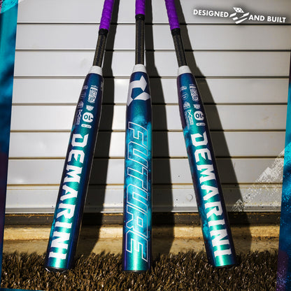 Three vibrant DeMarini 2026 Future (-10) Fastpitch Softball Bats (WBD2674010) stand upright against a metal garage door, showcasing FUTURE and DESIGNED AND BUILT on the barrels, ready to offer a large sweet spot for every player.