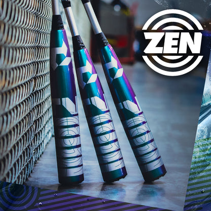 Three DeMarini ZEN Oil Slick (-10) 2 3/4" USSSA Baseball Bats (WBD2655010) lean against a chain-link fence on an indoor surface. A large ZEN logo with concentric circles highlights the Dark Matter Composite barrel.