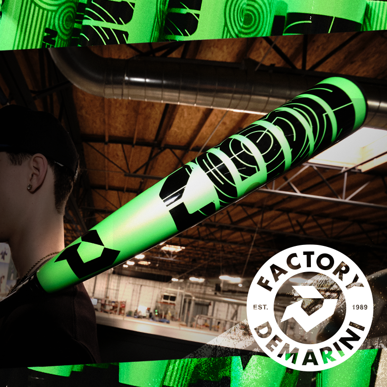 A person carrying a neon green and black DeMarini baseball bat over their shoulder inside a warehouse, with the Factory DeMarini logo and “EST. 1989” in the bottom right corner.