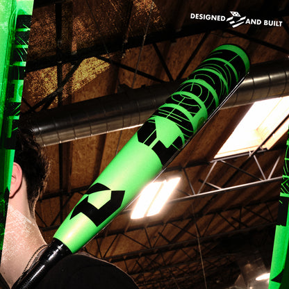 A man holding a DeMarini 2026 ZEN (-8) 2 3/4" USSSA Baseball Bat (WBD2592010) with two-piece construction.