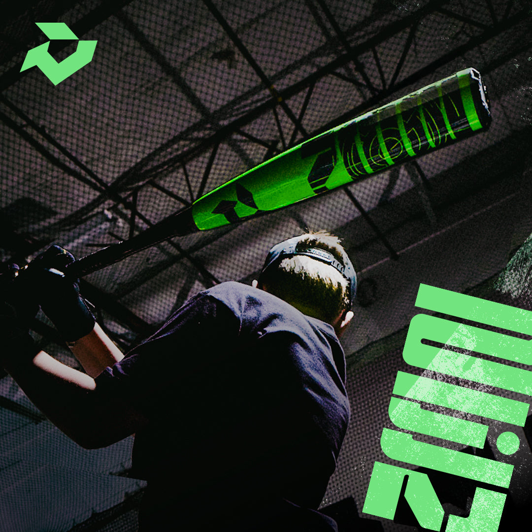 An athlete in sports gear readies a swing in an indoor cage, gripping the 2026 DeMarini ZEN (-8) 2 3/4" USSSA Baseball Bat (WBD2592010). Bold green graphics and the DeMarini logo appear in the upper left corner.