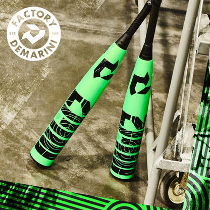 Two neon green 2026 DeMarini ZEN (-8) 2 3/4" USSSA Baseball Bats (WBD2592010) with black graphics and composite barrel lean against a metal structure, with the DeMarini logo in the top left on a distressed background.