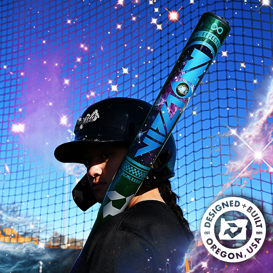 A softball player in a black helmet holds the DeMarini 2027 Vizion (-8) Fastpitch Softball Bat (WBD2730010) over their shoulder, standing before a blue net with a cosmic effect. A badge reads “Designed + Built in Oregon, USA.”.