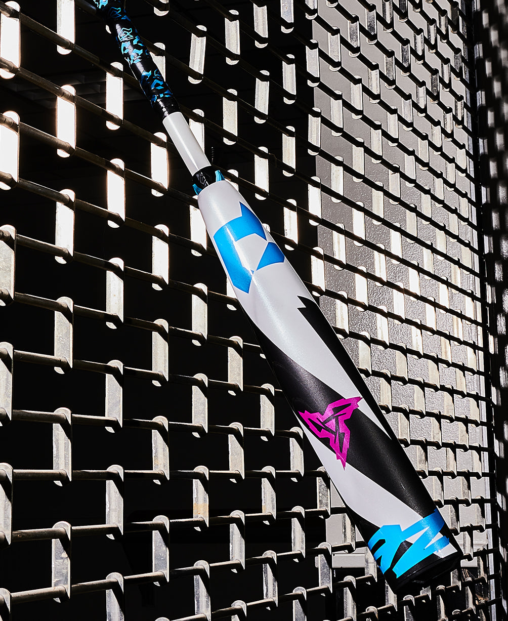 A 2025 DeMarini ZEN (-5) 2 3/4" USSSA Baseball Bat (USED), model WBD2534010, rests casually against a fence.