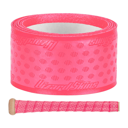 A roll of Lizard Skins DSP Ultra Solid 1.1mm Bat Grip in bright pink, featuring textured dots and diagonal lines, is displayed above a wooden handle wrapped in the same vibrant grip from Lizard Skins.