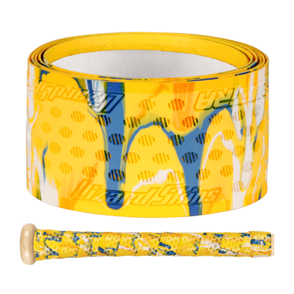 A roll of Lizard Skins DSP Ultra Camo 1.1mm Bat Grip in yellow with blue, white, and orange abstract patterns is shown next to a baseball bat handle wrapped with the same colorful grip by Lizard Skins.
