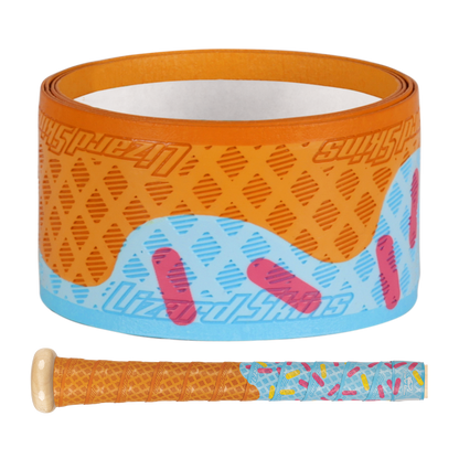 The Lizard Skins DSP Ultra Outburst 1.1mm Bat Grip in Blue Scoop features a waffle cone and sprinkles design, shown rolled up above a matching-wrapped bat handle, resembling an ice cream cone and offering superior polymer durability.