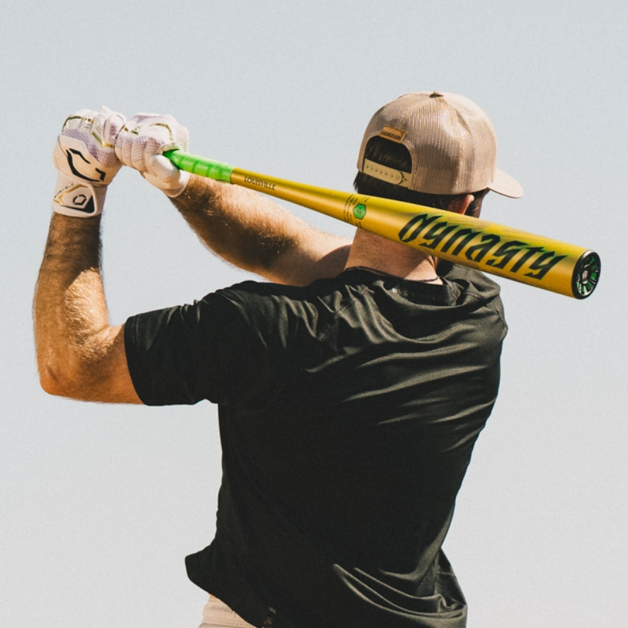 A man grips the 2026 Louisville Slugger Dynasty (-3) BBCOR Baseball Bat (WBL4162010), ready to step up to the plate.